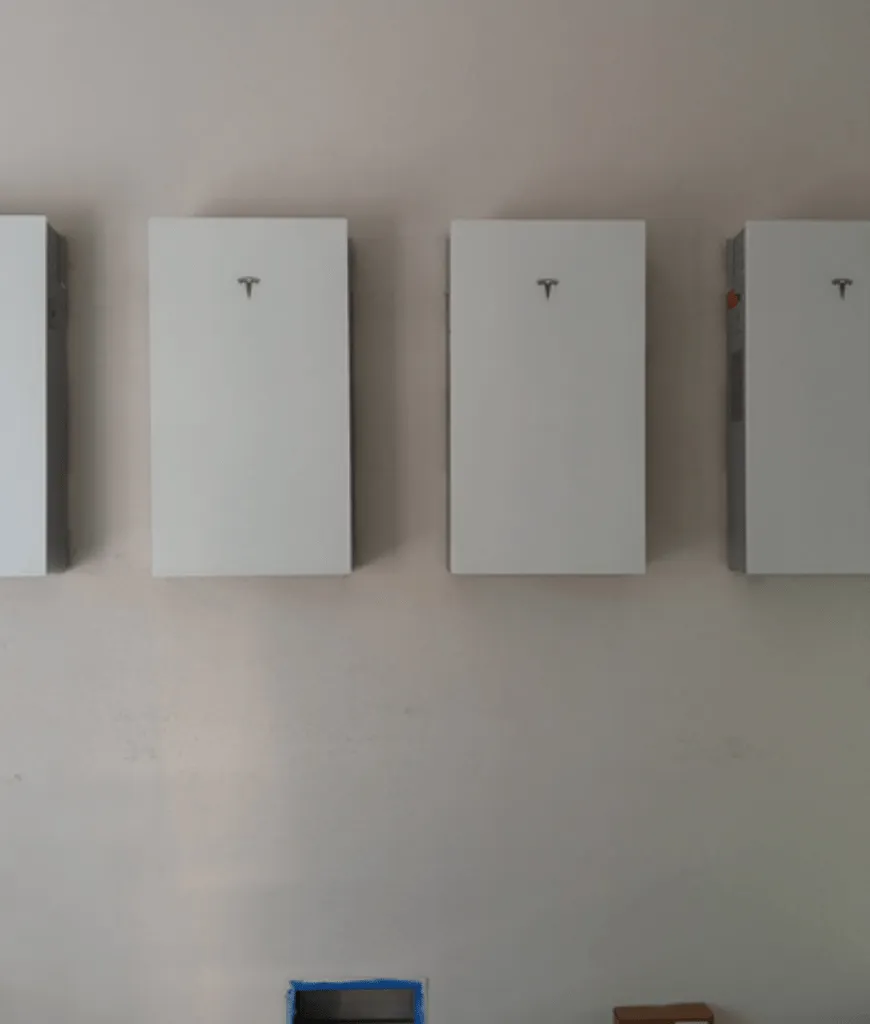 Three Tesla Powerwall batteries mounted on a Florida home exterior wall