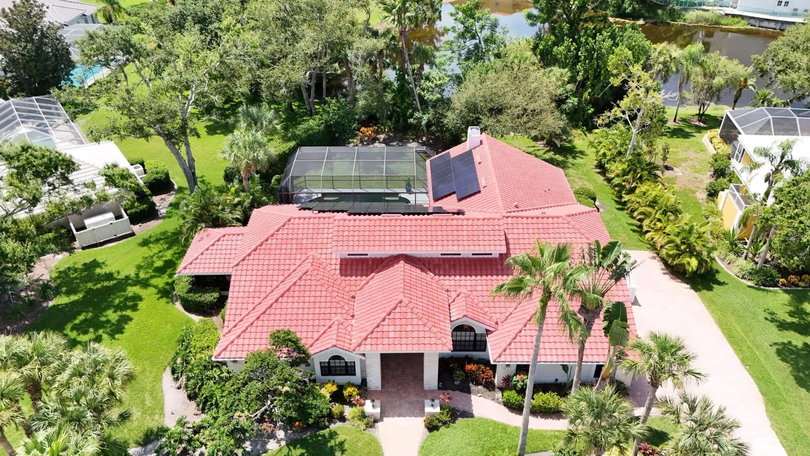Aerial view of a Florida home with solar panels installed on a red tile roof