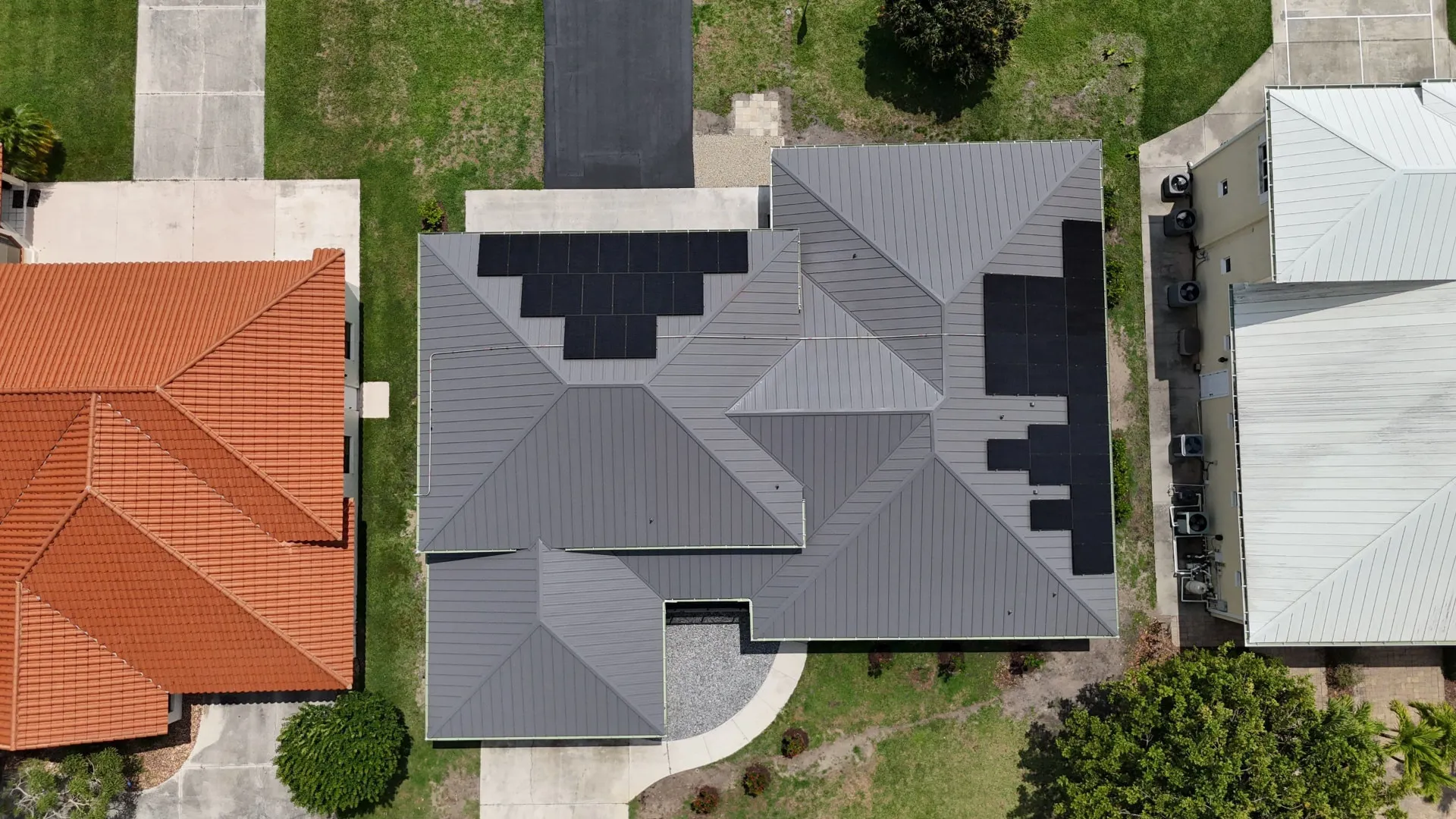 Top down aerial of a metal roof solar array on an elevated Keys home