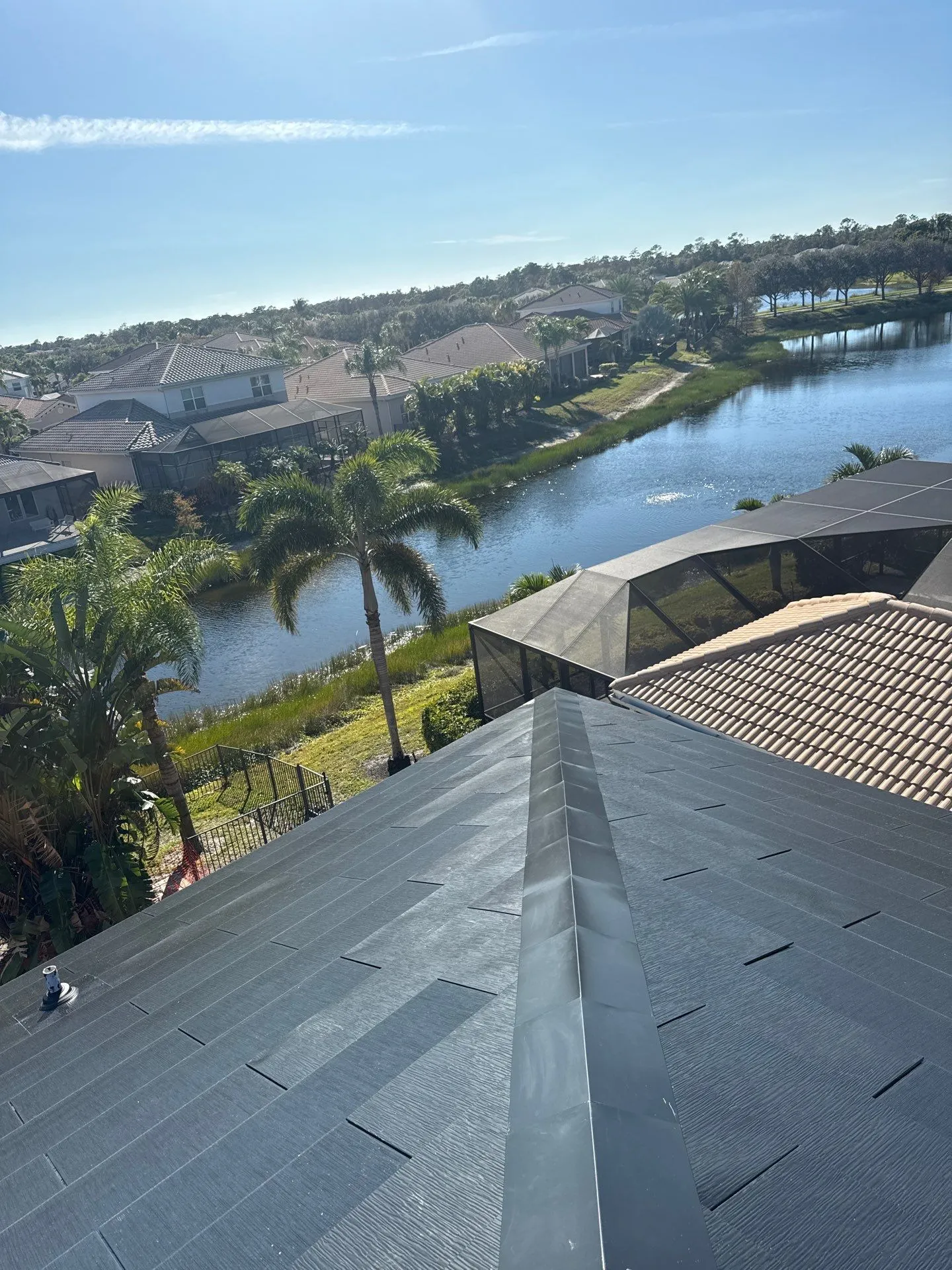 New dark metal roof on a Florida canal home installed by Coastal Energy