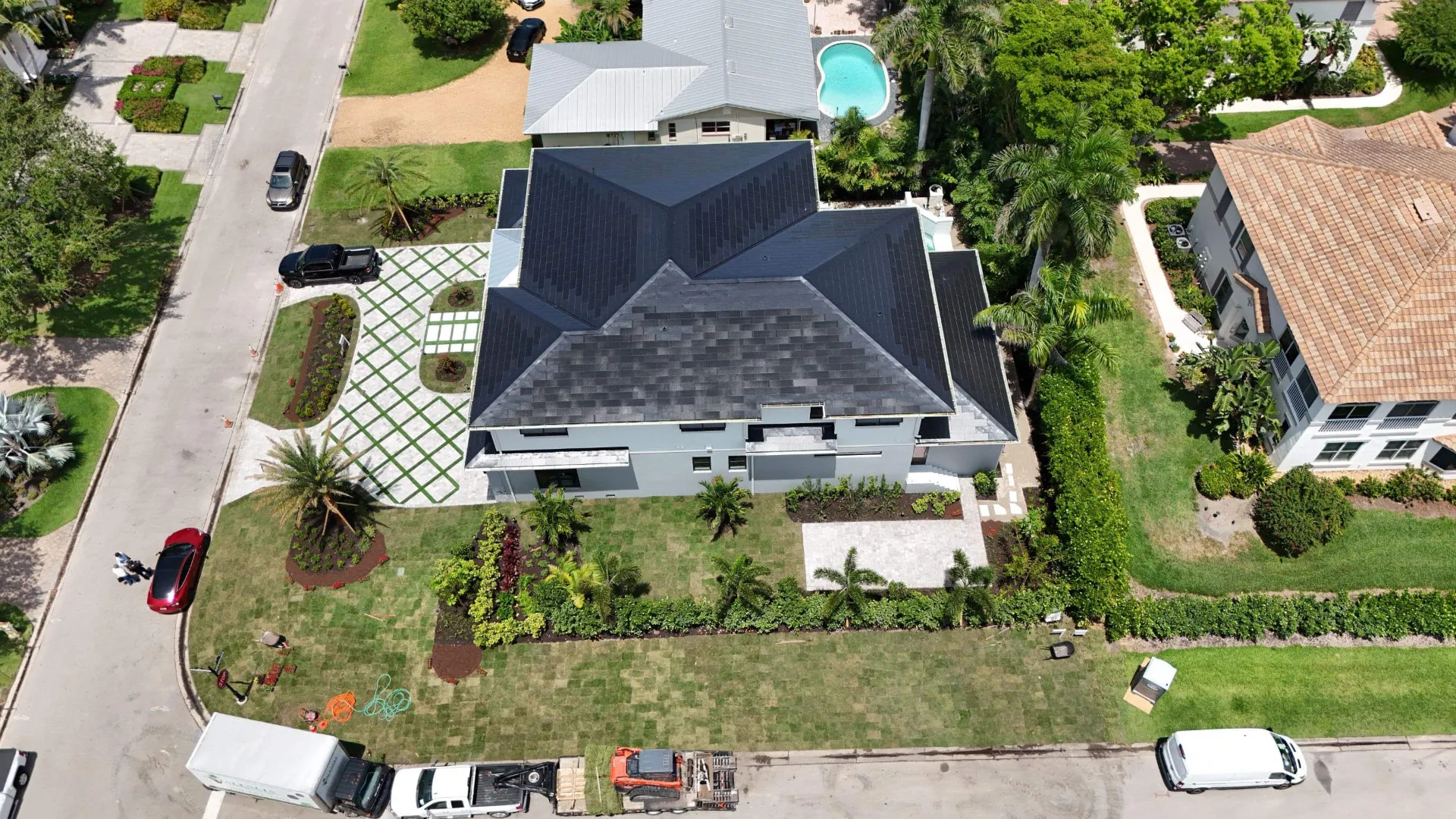 Top down aerial of a newly completed dark tile roof on a Coral Springs, Florida home