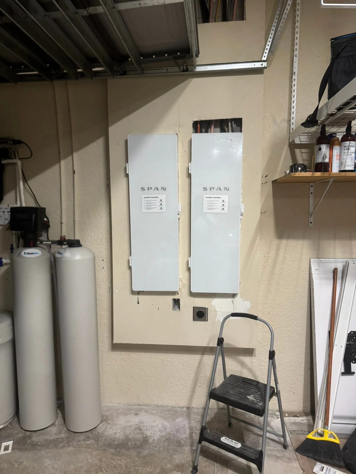 Two SPAN smart electrical panels mounted on a Florida garage wall