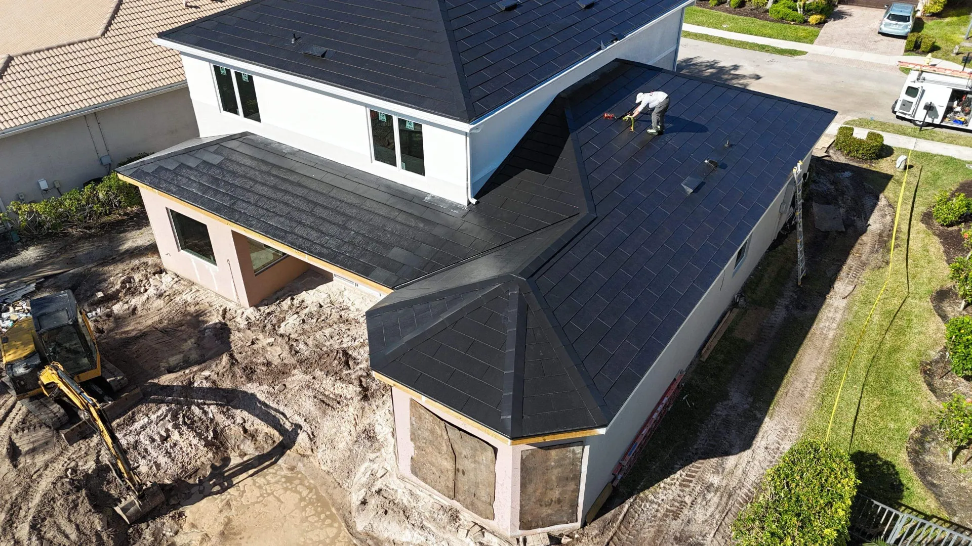 Aerial of a new construction Florida home receiving a dark solar tile roof