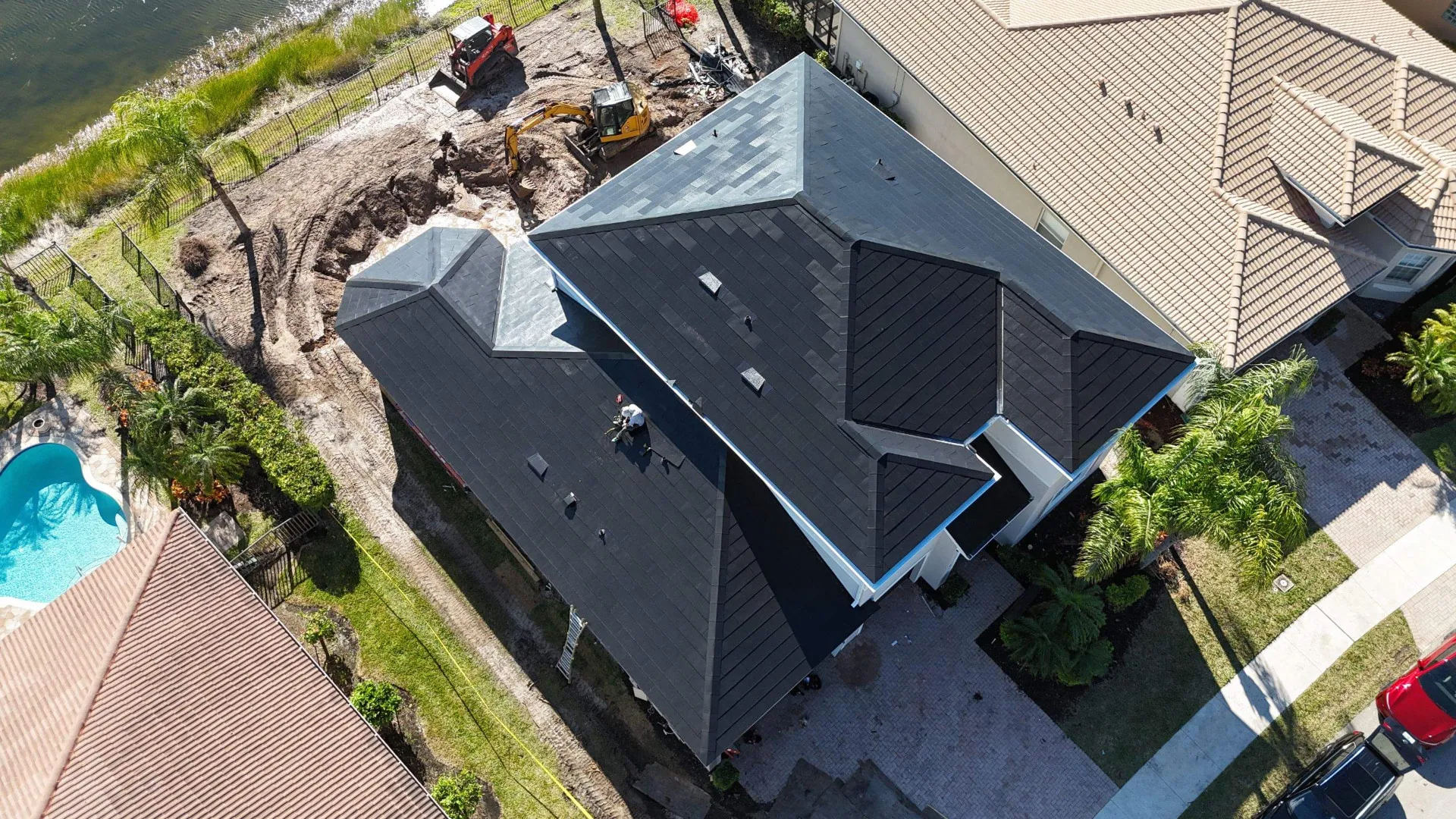 Aerial of a Florida re-roof in progress with crew and equipment on site