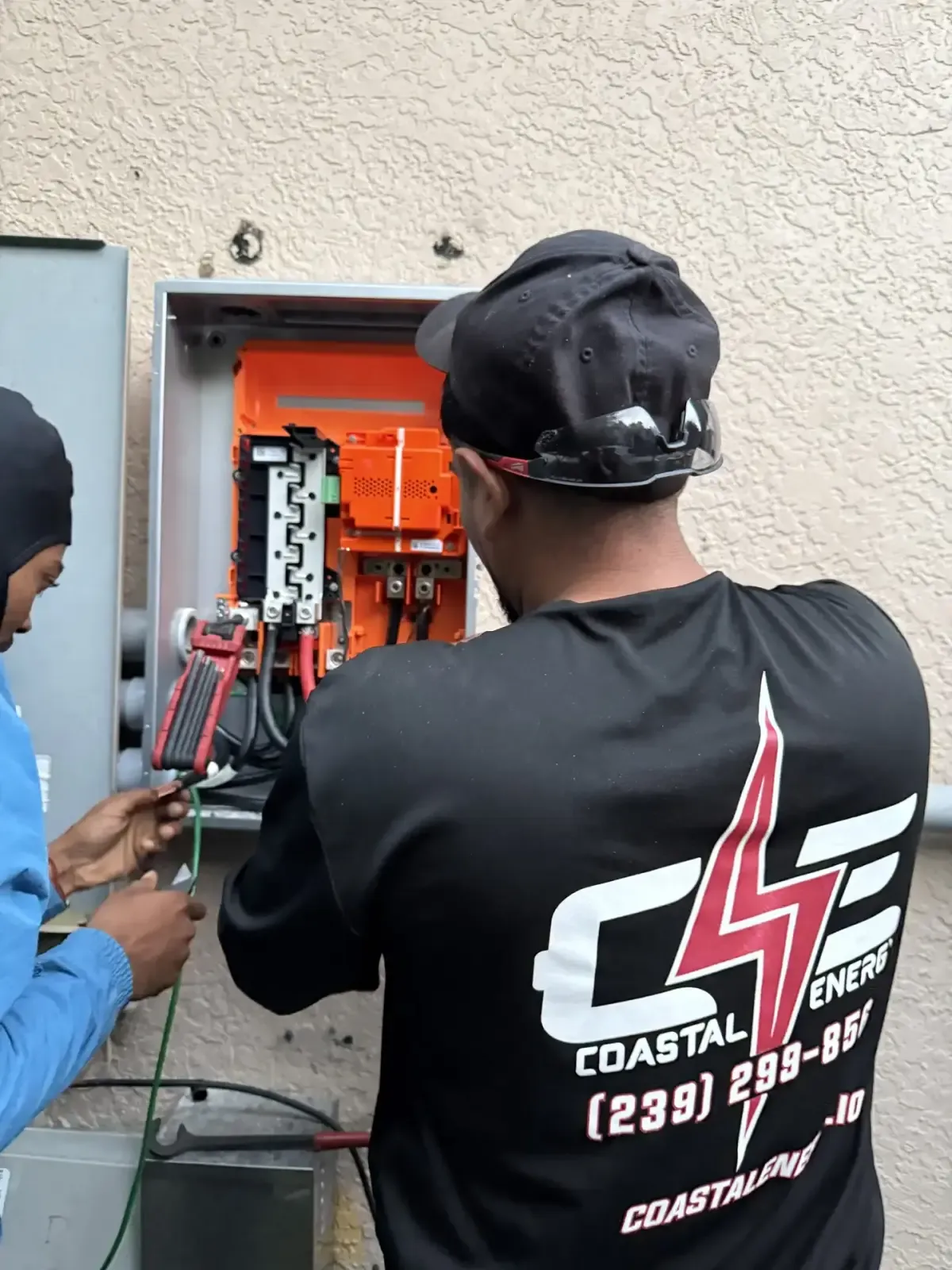 Coastal Energy service technician inspecting a solar electrical panel in Florida
