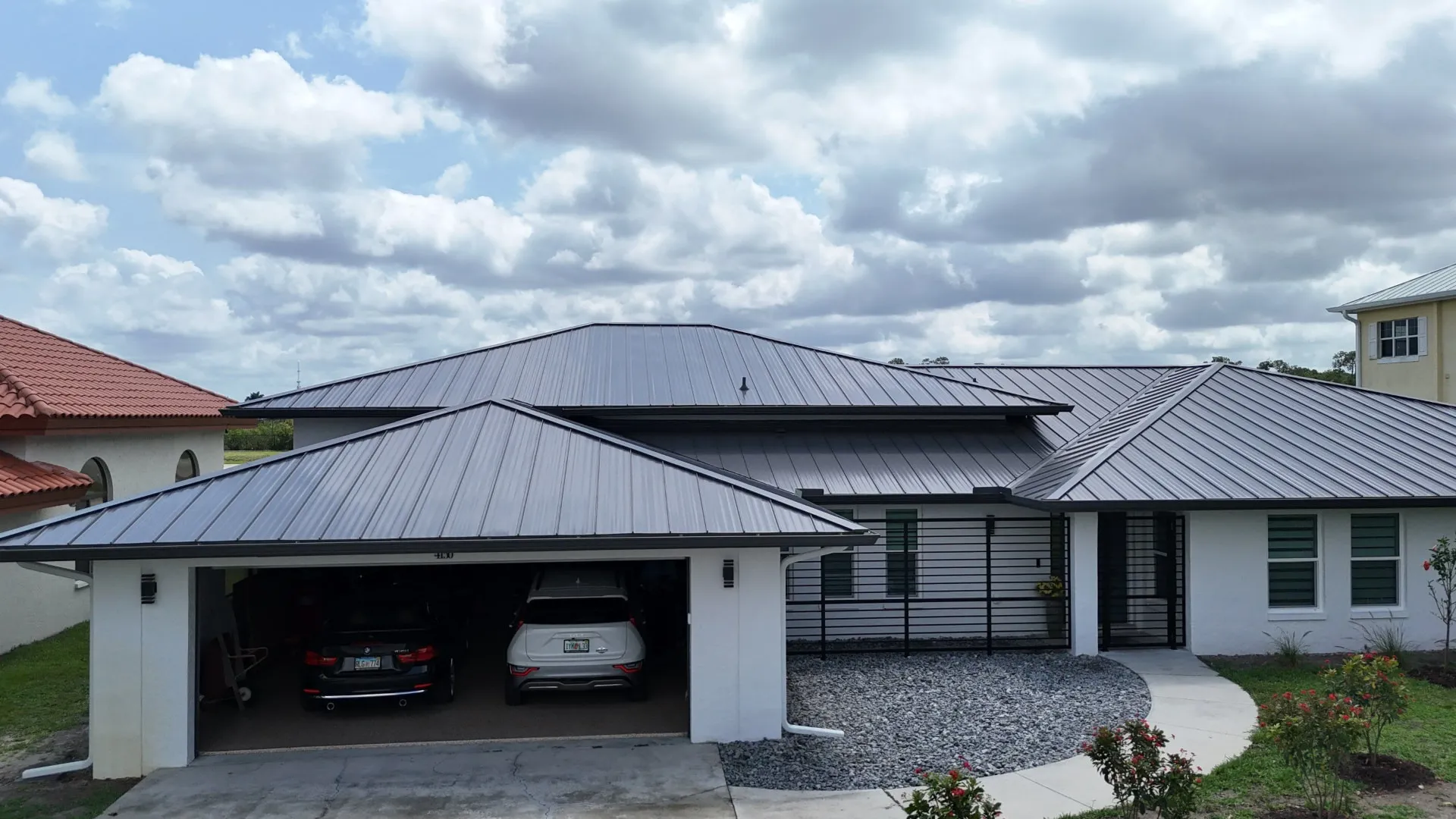 Front elevation of a Florida home with a new dark standing seam metal roof