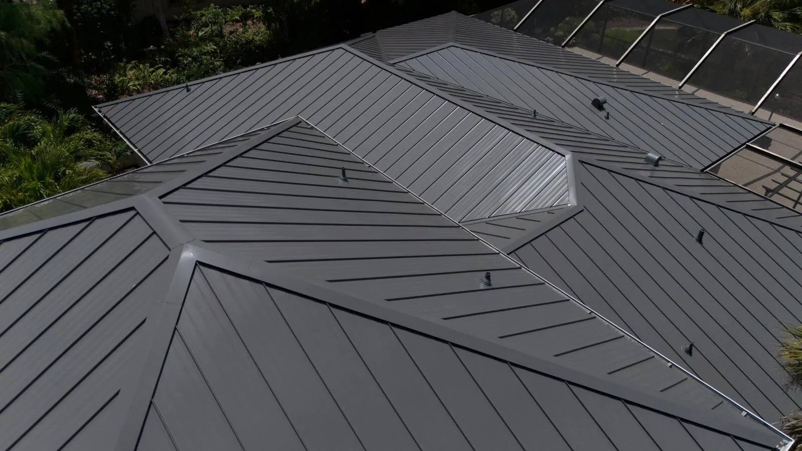 Close up of standing seam metal roof panels, valleys and vent boots on a Florida roof