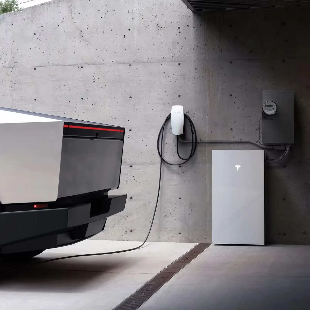 Tesla Cybertruck parked in a garage beside a Tesla Wall Connector, Powershare Gateway and utility meter