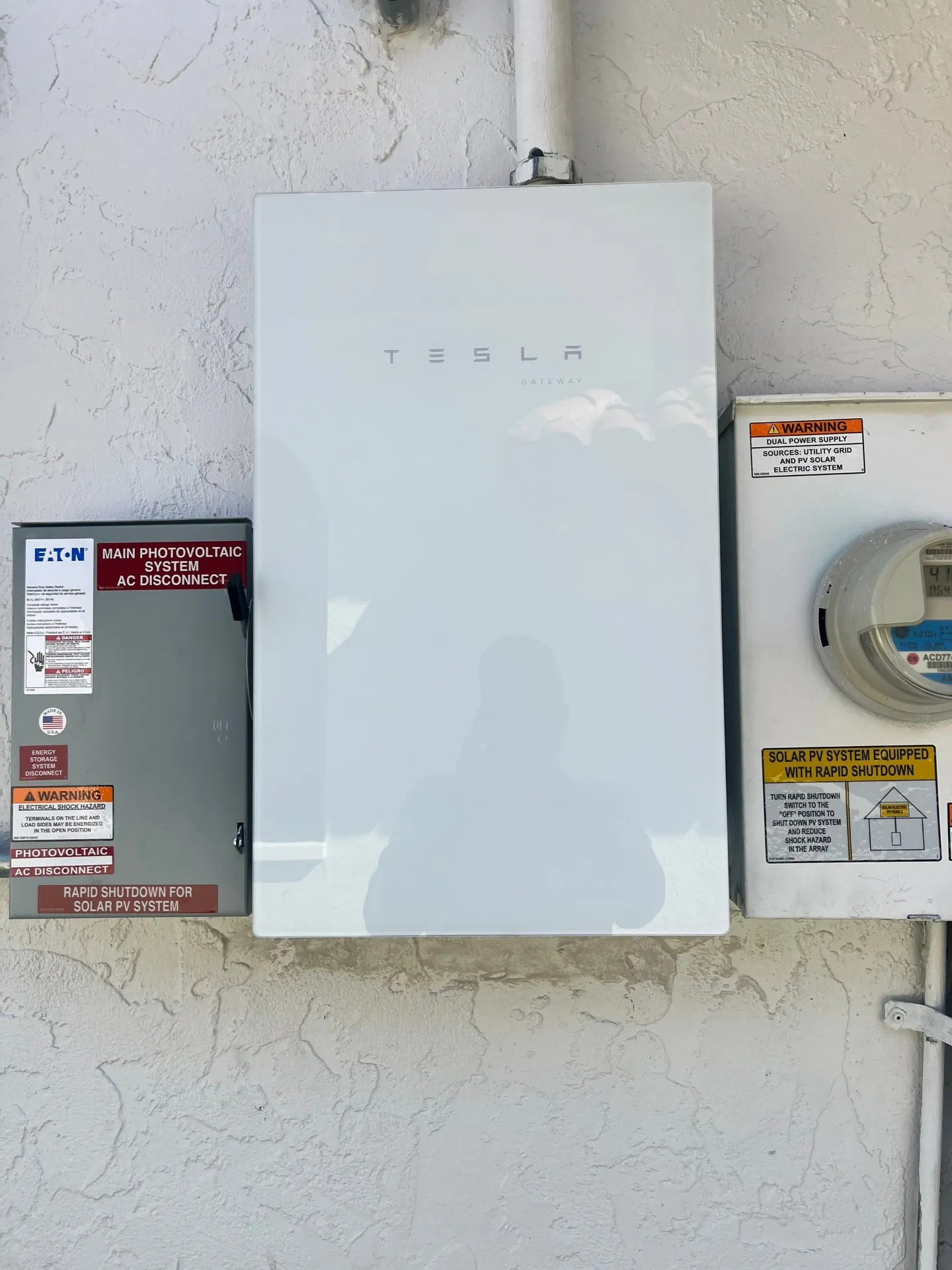 Tesla Gateway installed beside the AC disconnect and utility meter on a Florida home